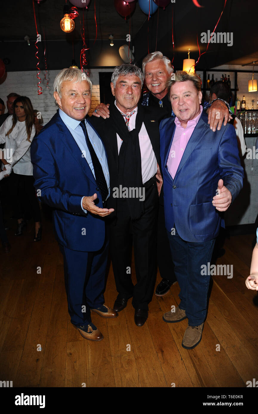 Frazer Hines, Billy Murray, Jess Conrad and David Van Day seen during the 70th birthday of Elaine Murray with friends and family at Pepenero restaurant in Camden London. Stock Photo