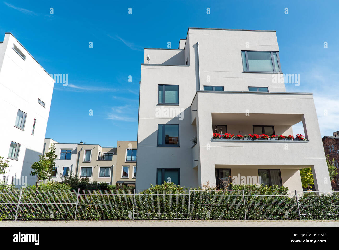 White modern houses in front of a blue sky seen in Berlin, Germany