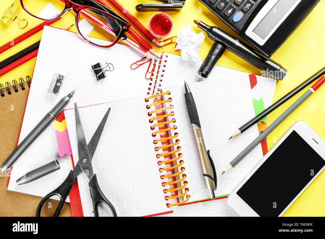 Workplace composition with smartphone, notebooks and stationery on table, flat lay Stock Photo