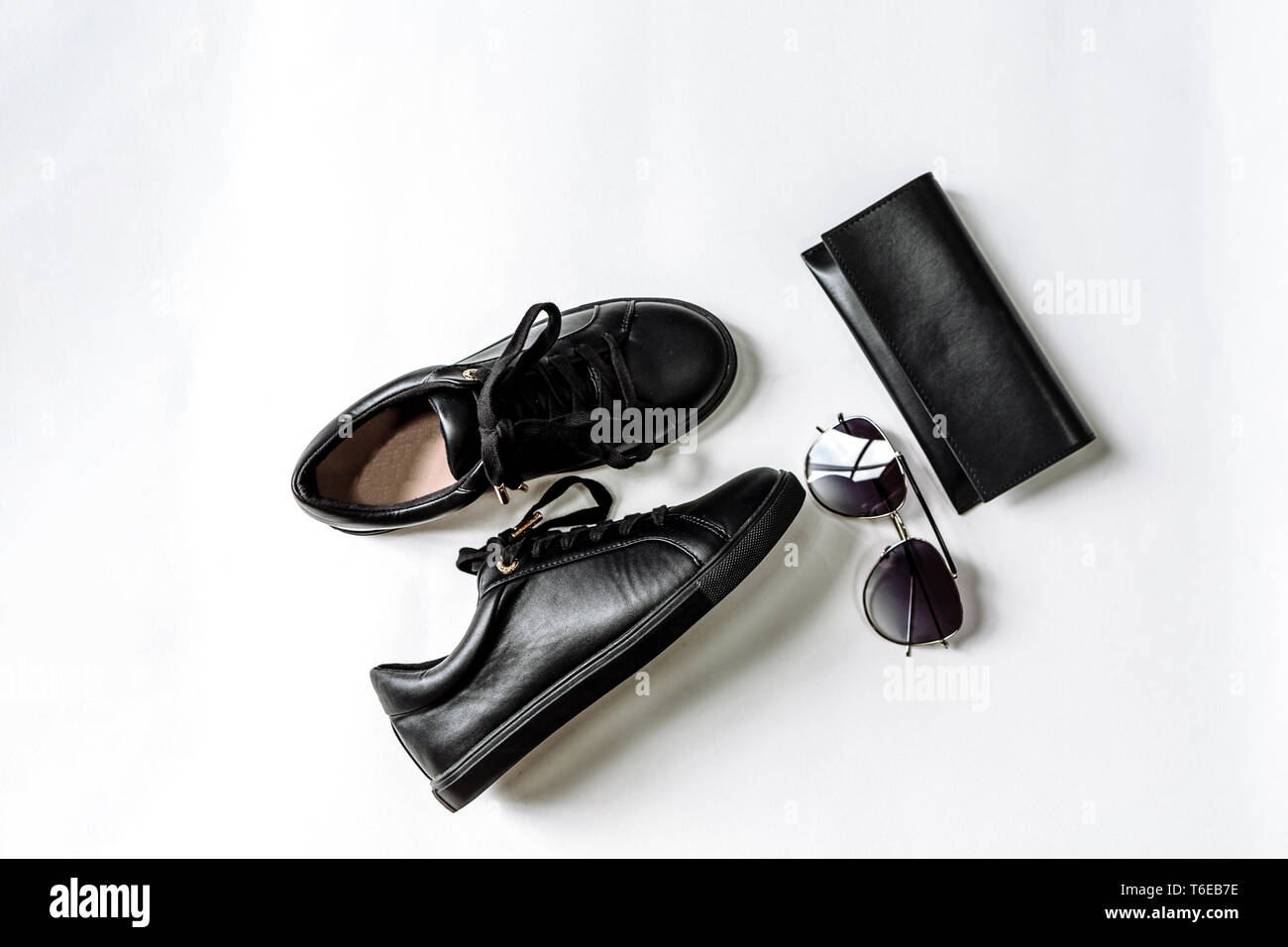 fashionable black shoes, purse and sunglasses with black lenses on a light background Stock Photo