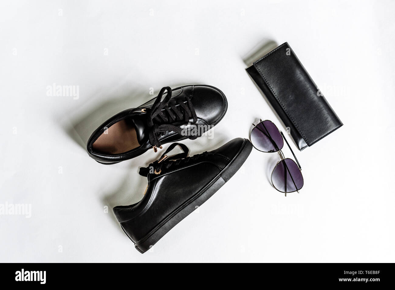 fashionable black shoes, purse and sunglasses with black lenses on a light background Stock Photo