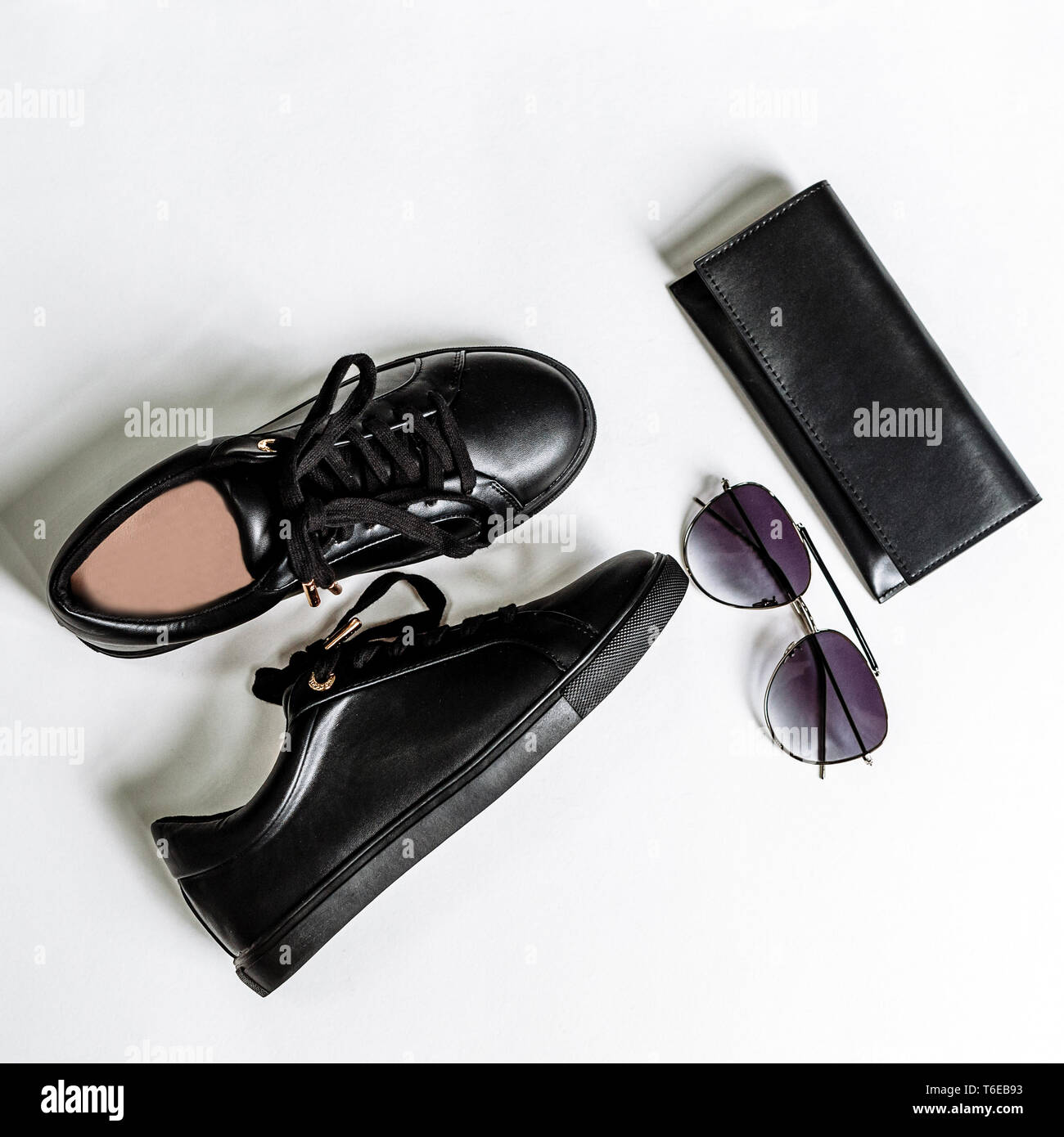 fashionable black shoes, purse and sunglasses with black lenses on a light background Stock Photo