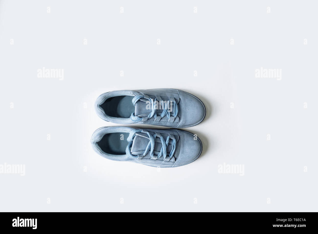 pair of fashionable blue suede shoes with thick laces on a white background Stock Photo