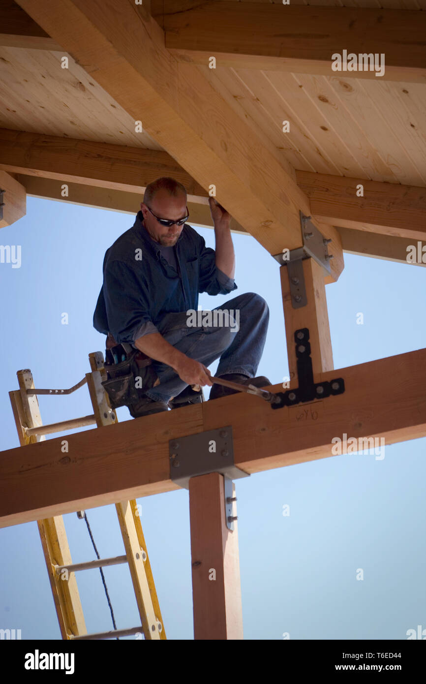 Focused builder working on a construction site. Stock Photo