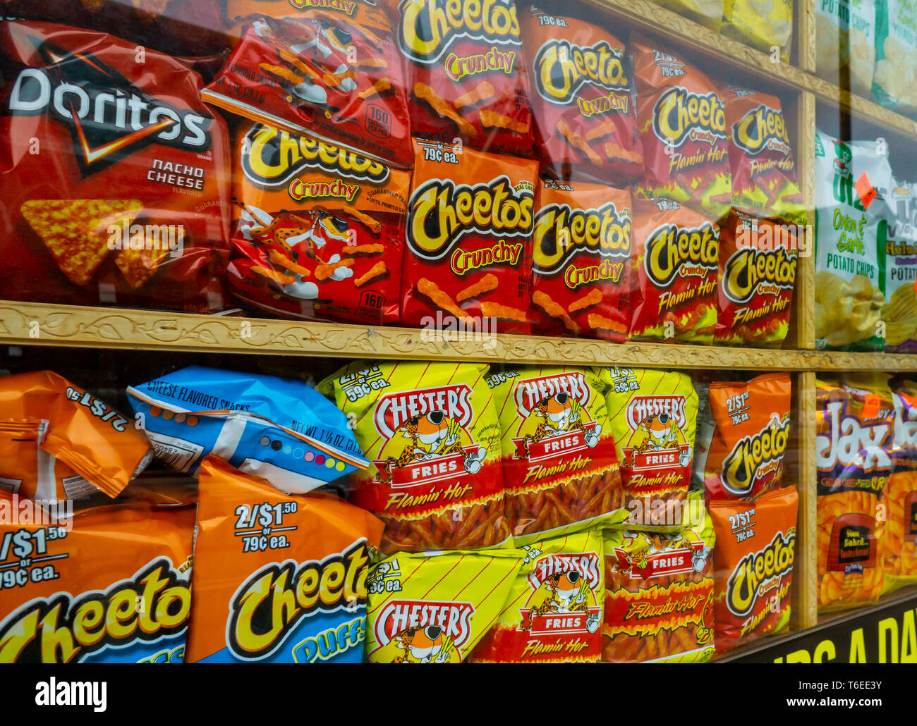 A window display of tasty Frito-Lay brand Cheetos chips with other snacks in New York on Sunday, April 28, 2019. Frito-Lay is a brand of Pepsico. (Â© Richard B. Levine) Stock Photo