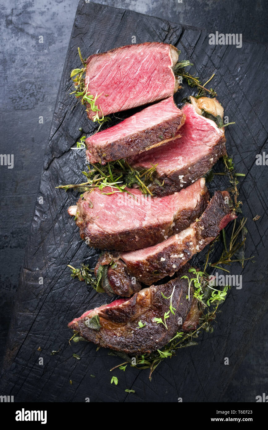 Kobe Ribs Barbecue dry aged Kobe rib eye steak as close-up on a burnt board Stock ...