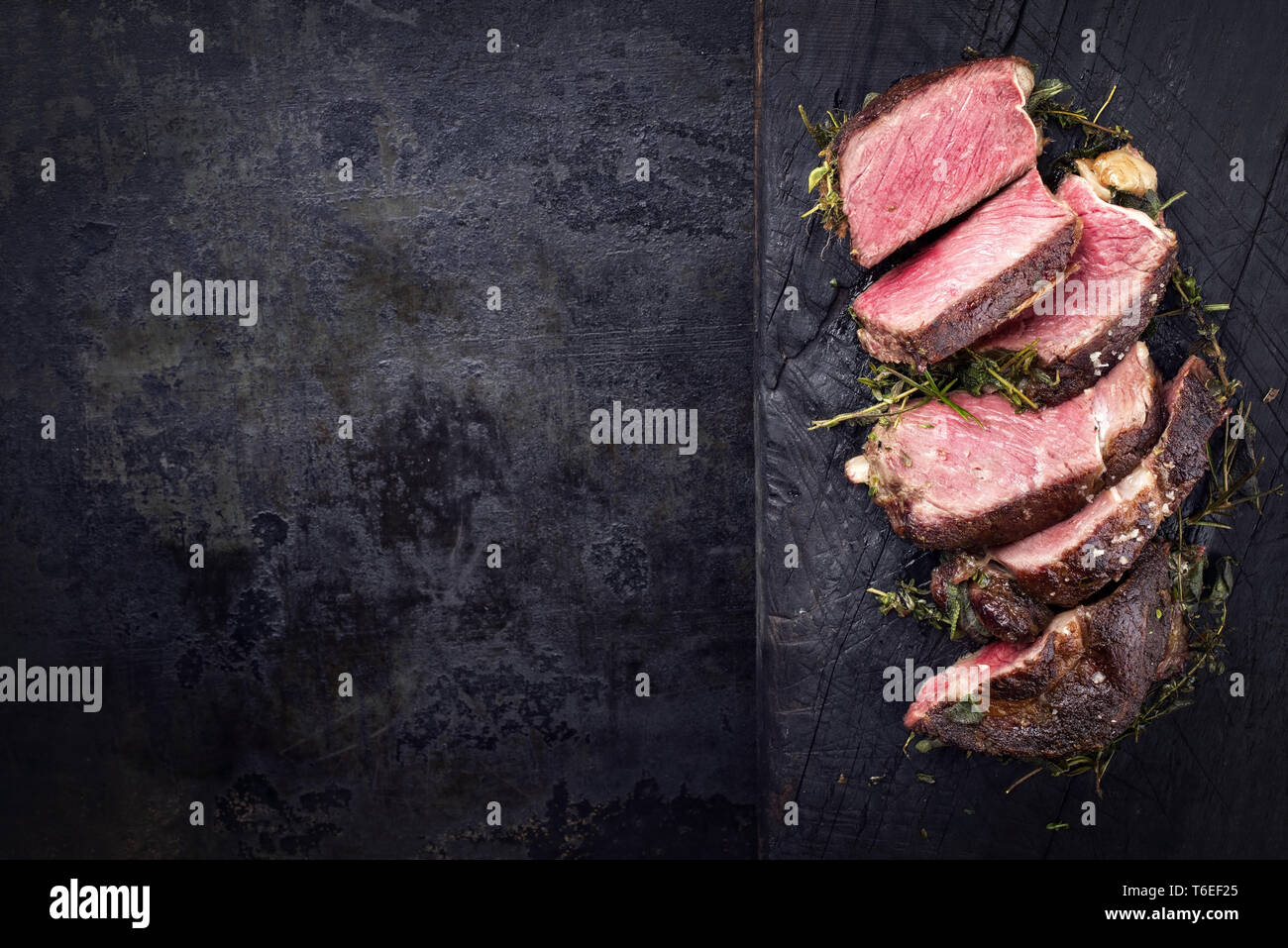 Kobe Ribs Barbecue dry aged Kobe rib eye steak as close-up on a burnt board with ...