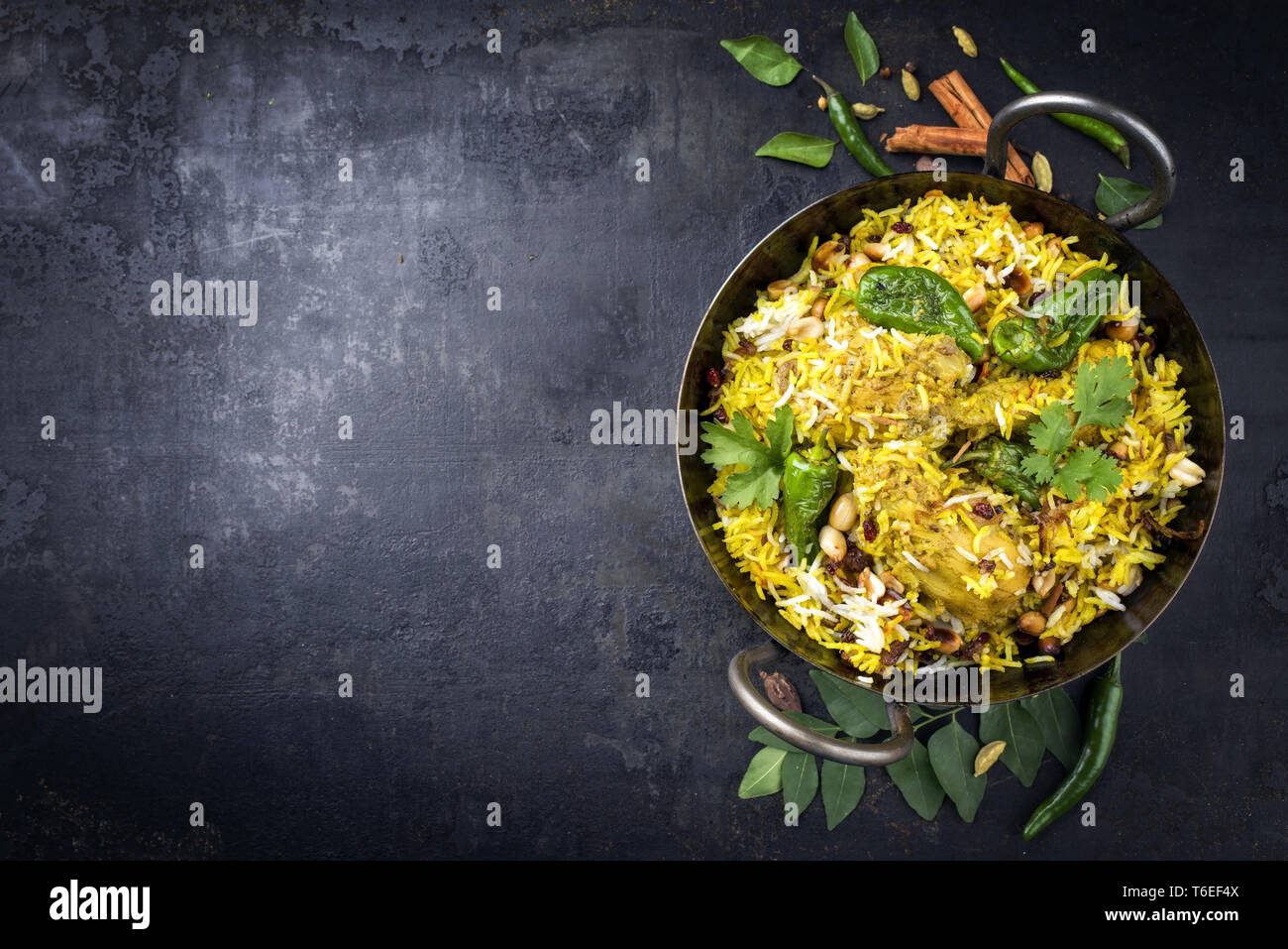 Traditional Indian chicken biryani with nuts and raisins as close-up in ...
