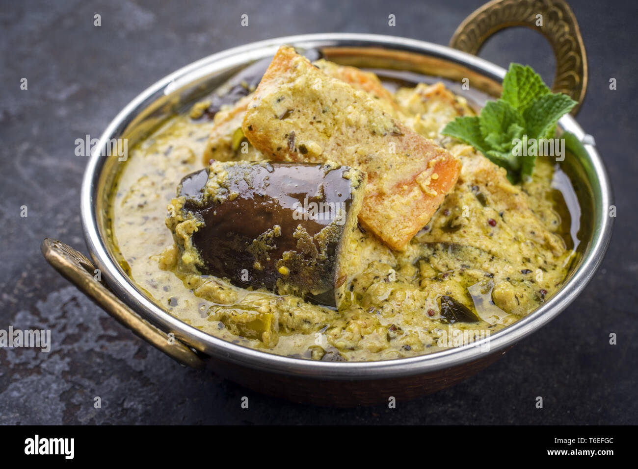 Traditional Indian Vegetable Curry with Sweet Potatoes and Eggplant as closeup in a Korai Stock