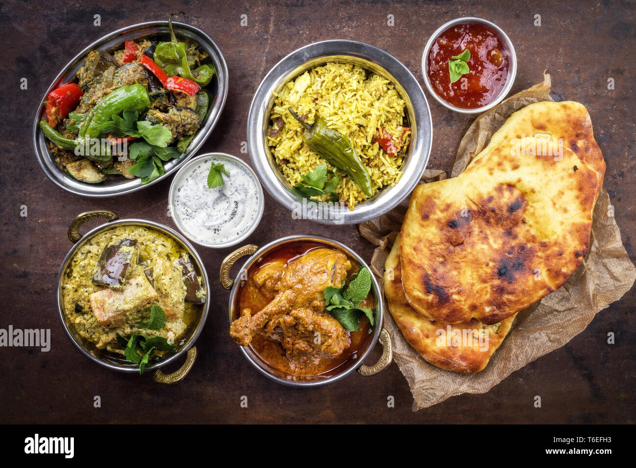 Traditional Indian Curries and Biryani with Mango Chutney and Pita