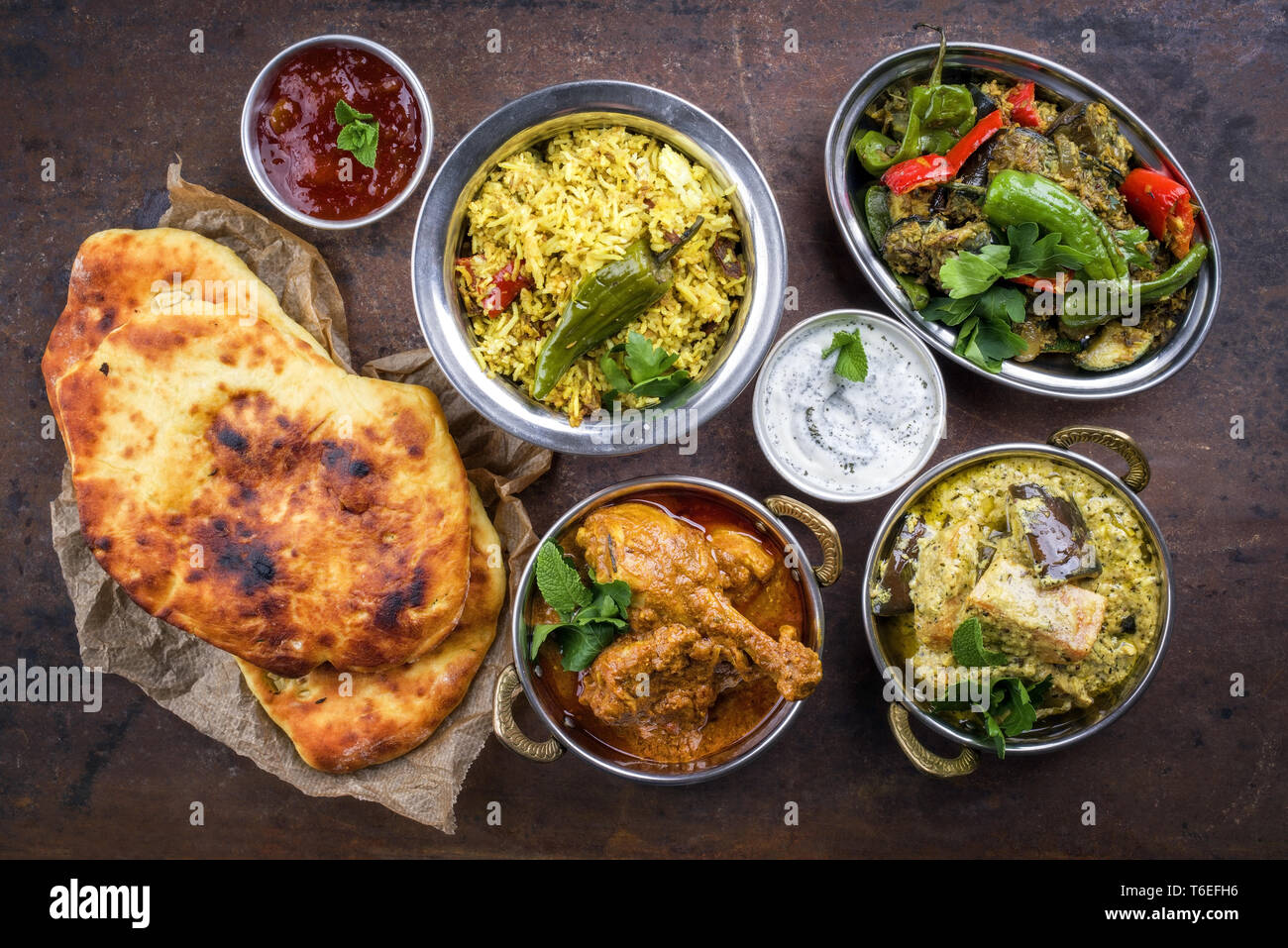Traditional Indian Curries and Biryani with Mango Chutney and Pita Bread as top view Stock Photo