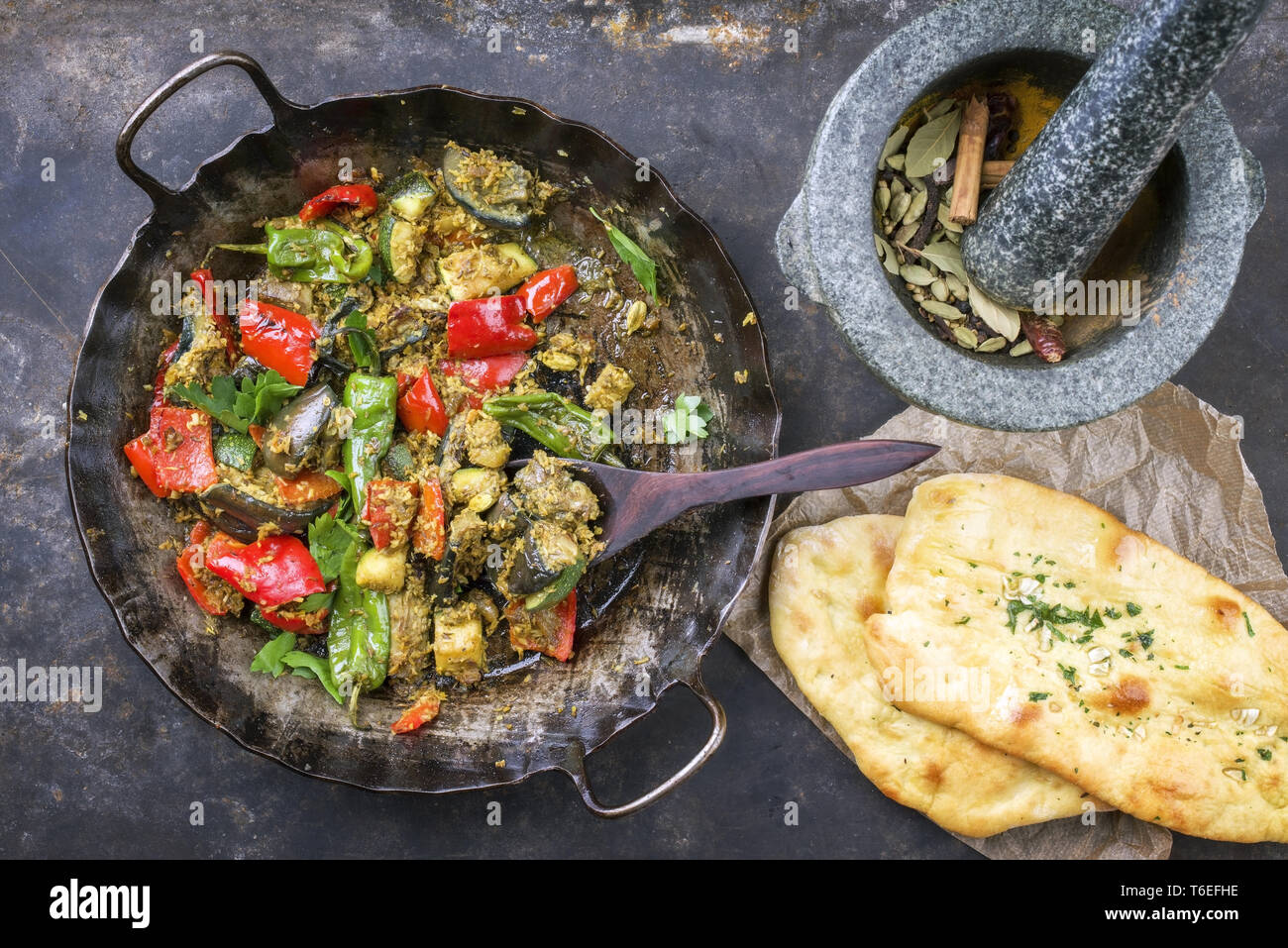 Indian Vegetable Curry Fry with Pita Bread as closeup in a in a frying