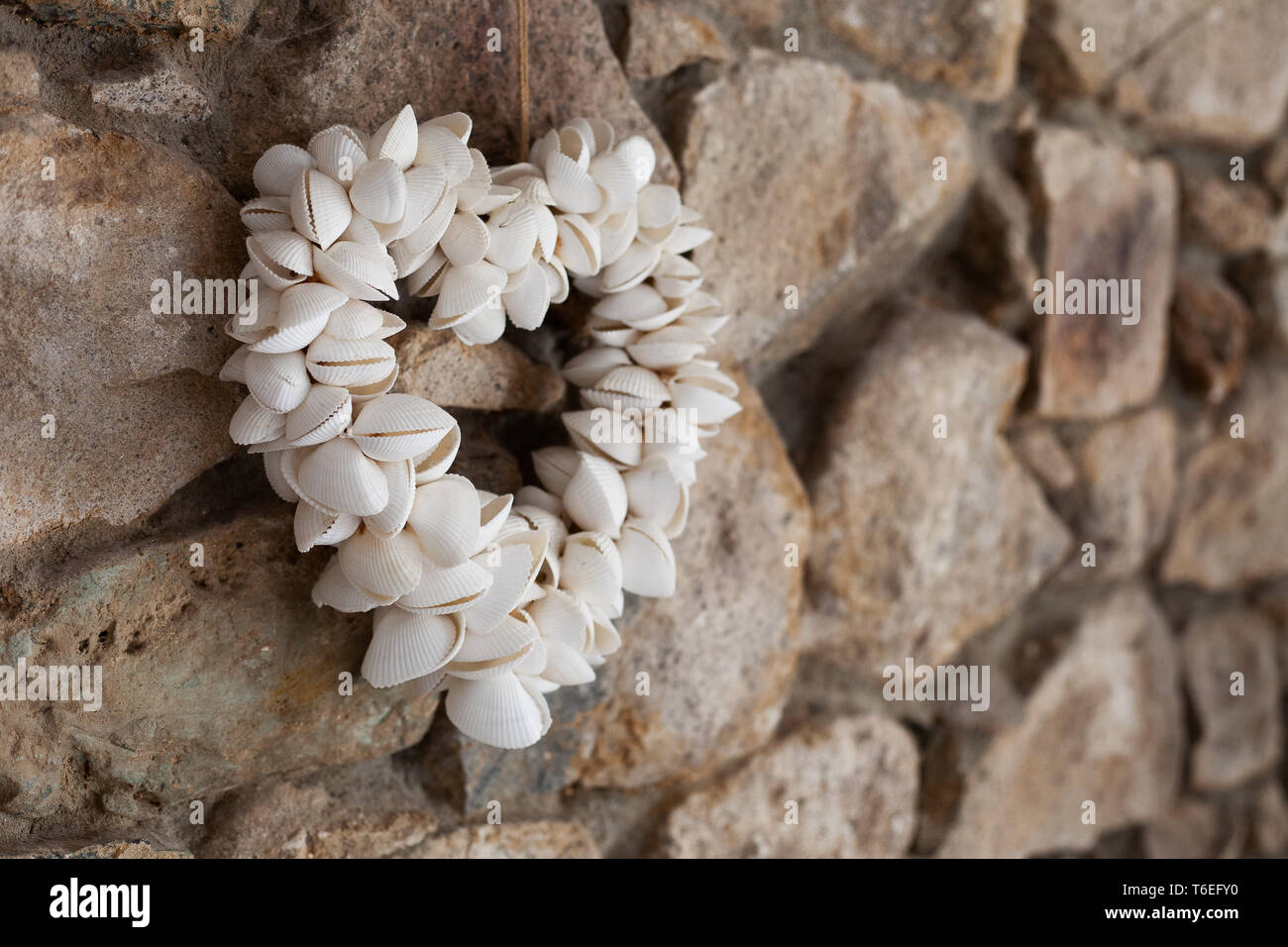 A Heart Decoration Made From Shells Hanging On A Stone Wall Stock Photo Alamy