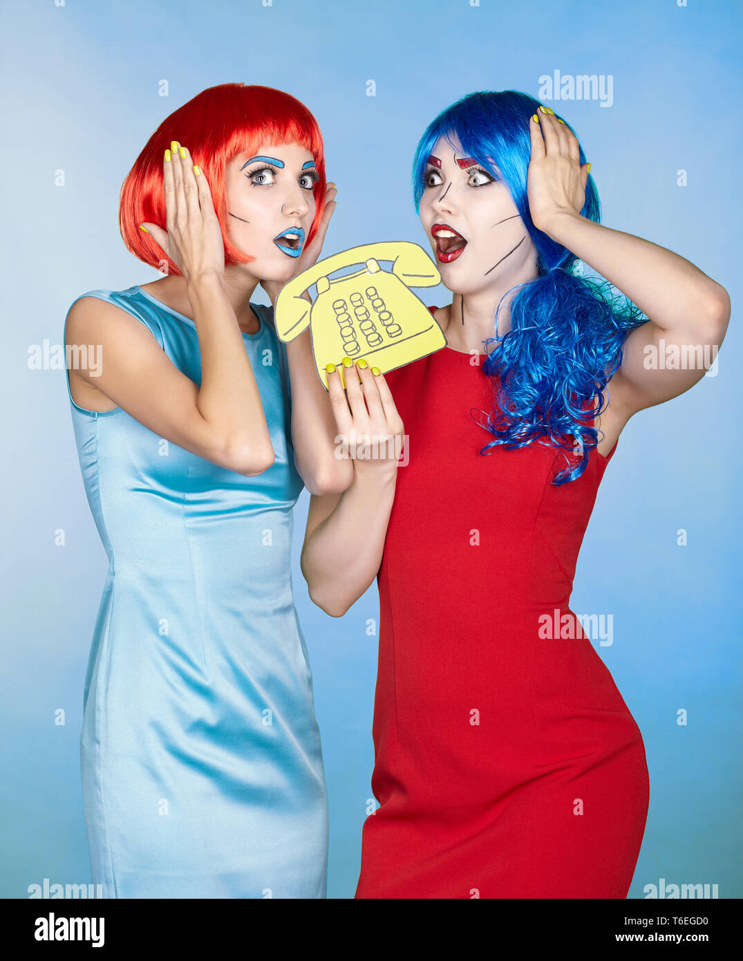 Portrait of young women in comic pop art make-up style. Females in red and  blue wigs call on the phone Stock Photo - Alamy