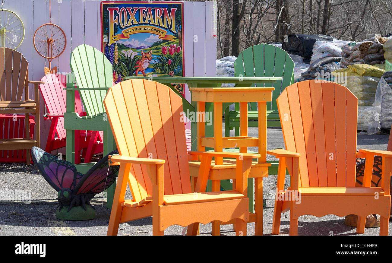Brightly colored wooden lawn chairs on display Stock Photo Alamy