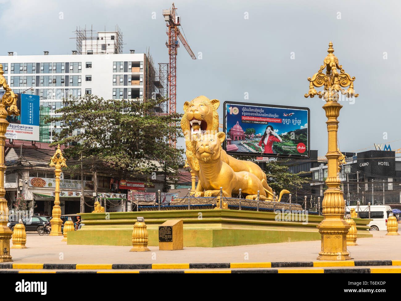 Sihanoukville, Cambodia - March 15, 2019: Golden Lions Roundabout. Front of giant statues of the beasts. Lanterns, Construction and cranes. Stock Photo