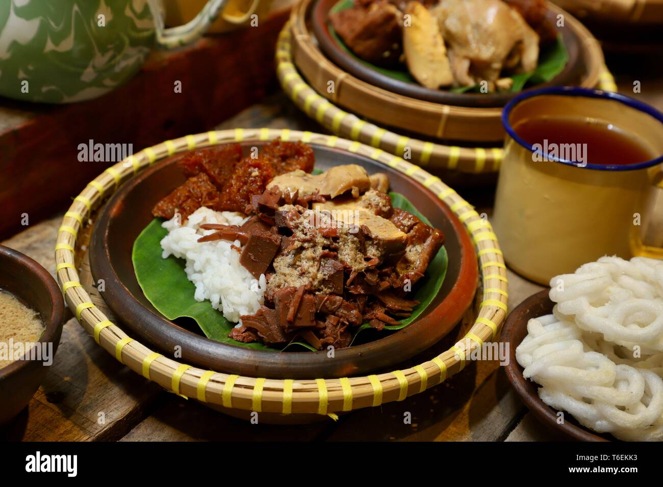 Nasi Gudeg. Traditional Javanese meal of steamed rice with jackfruit stew, chicken curry, and cattle skin cracker stew. Stock Photo