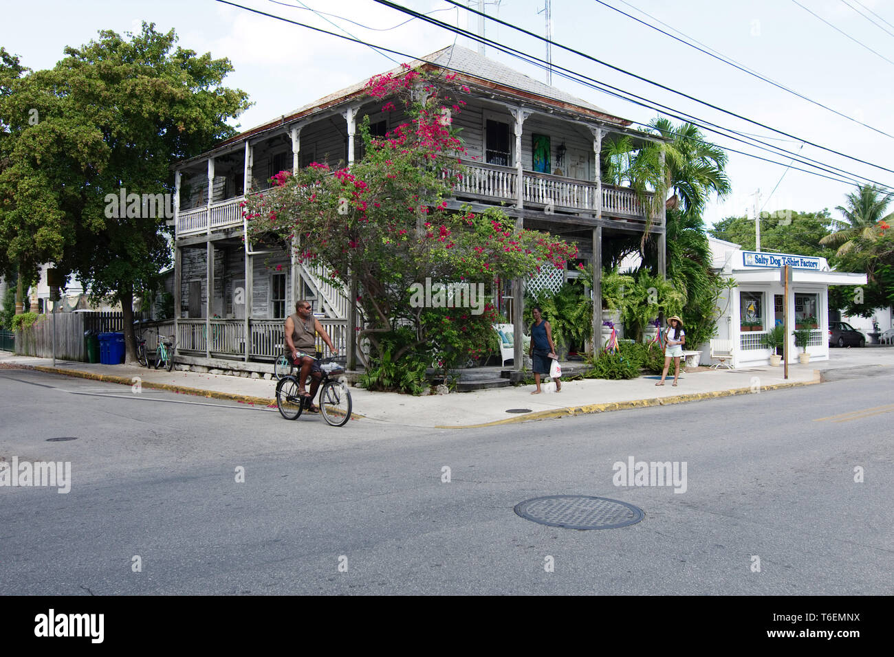 Key West, Florida, USA - 2019: People ride bicycles on a sunny day at the downtown district, as it is customary in this small touristic town. Stock Photo