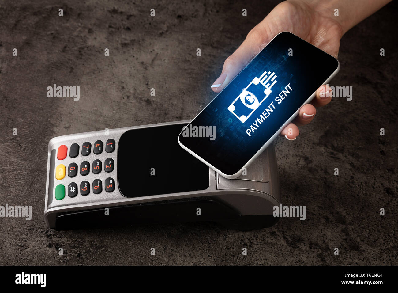 Hand paying with digital currency from smartphone  Stock Photo