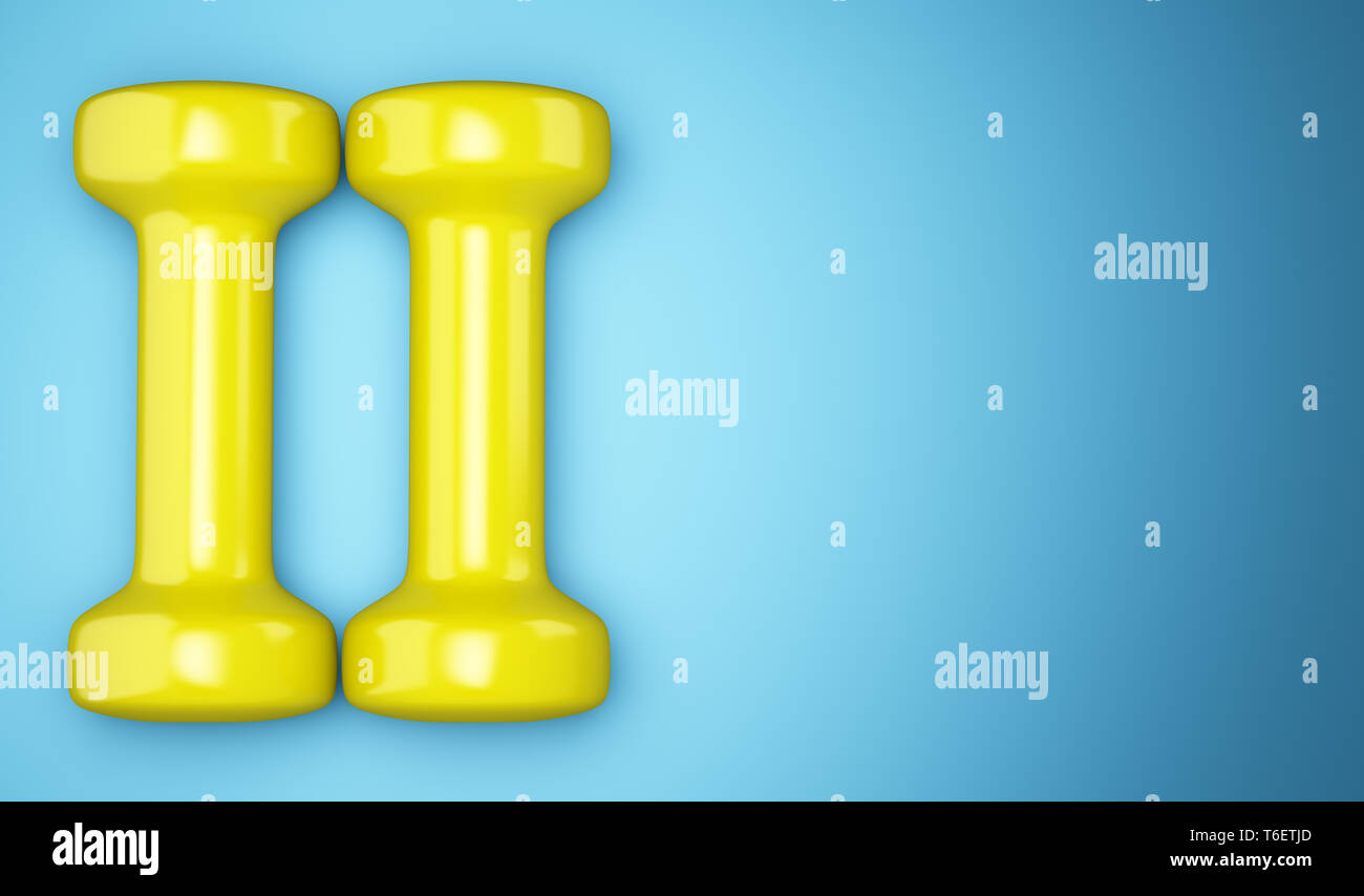 yellow dumbbells isolated on blue background Stock Photo