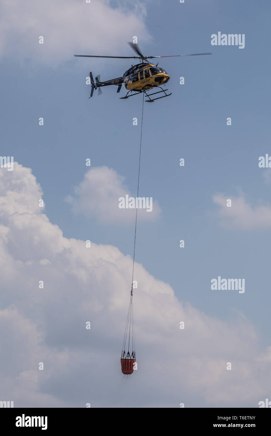 Helicopter with water tank for extinguishing fires, Beromünster, Lucerne, Switzerland, Europe Stock Photo