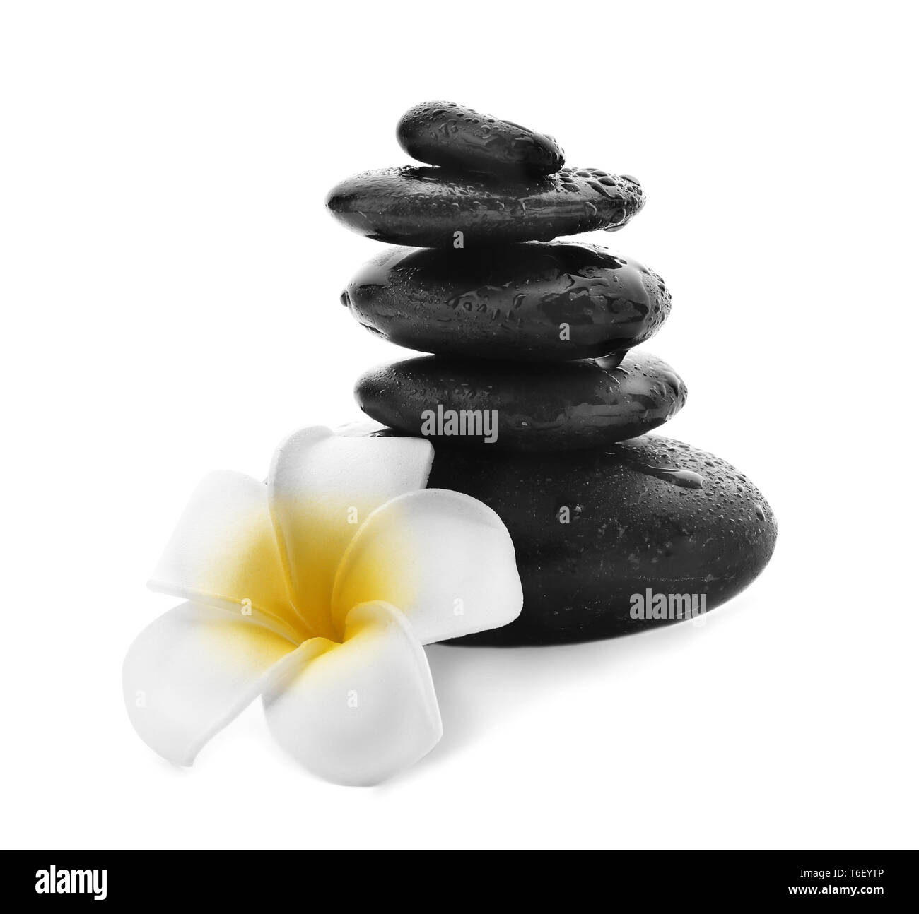 Stack of spa stones and flower on white background Stock Photo - Alamy