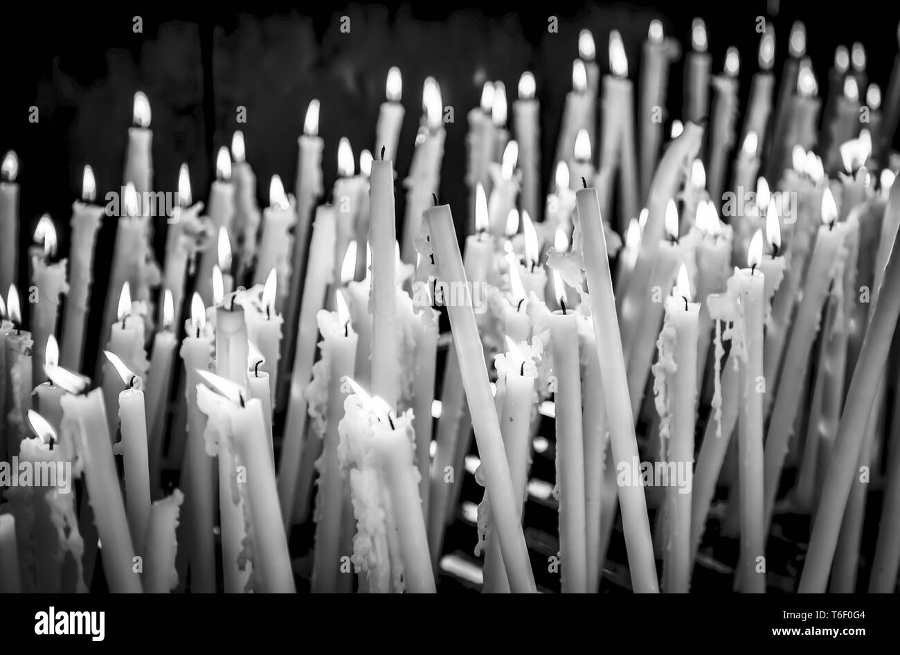 Church candles lit, detail of illumination and flame, belief and faith Stock Photo Alamy