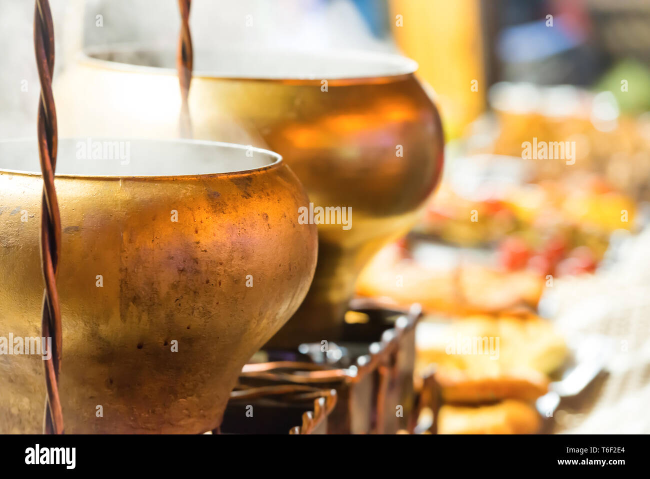 Boiling brass cauldrons Stock Photo Alamy