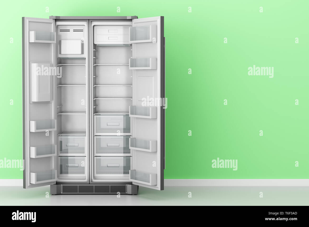 open empty fridge in front of green wall Stock Photo