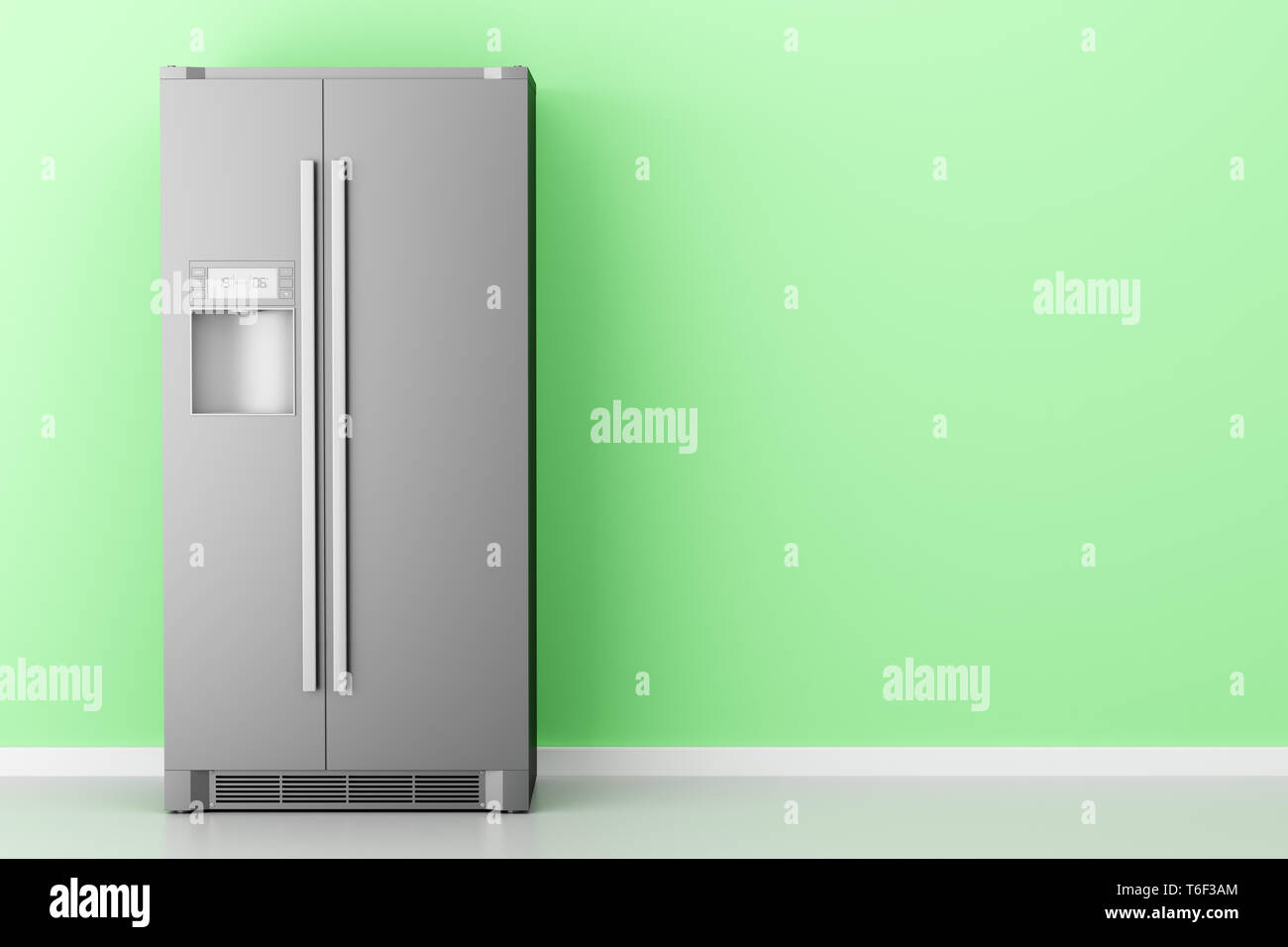 modern fridge in front of green wall Stock Photo