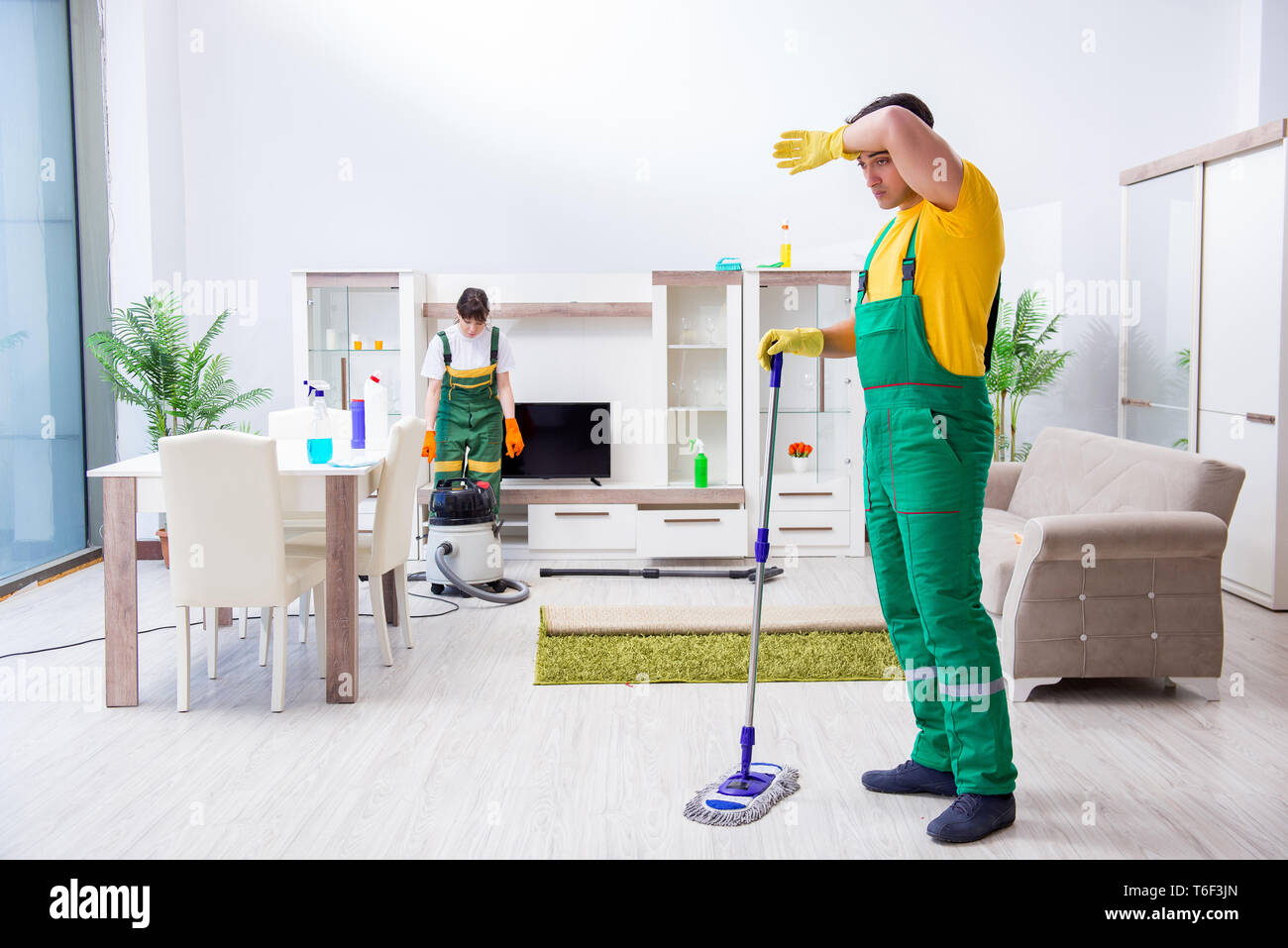 Cleaning professional contractors working at house Stock Photo - Alamy