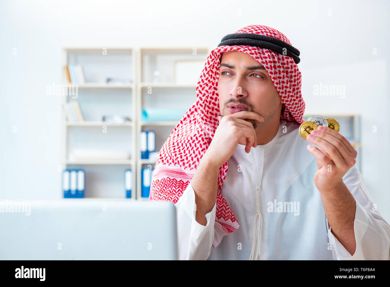 Arab man with bitcoin in cryptocurrency mining concept Stock Photo - Alamy