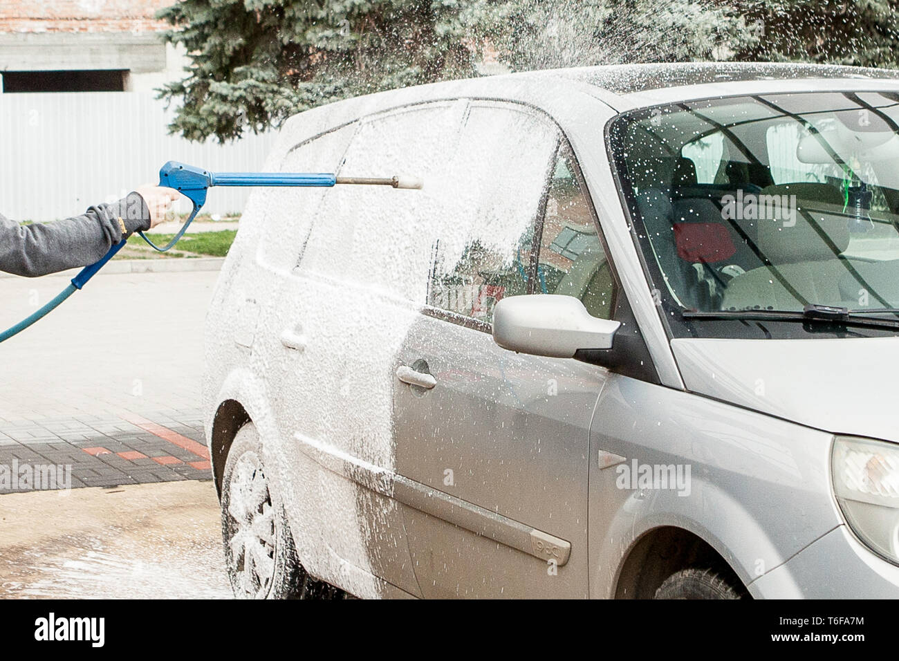 Car wash with foam in car wash station. Carwash. Washing machine at the  station. Car washing concept. Car in foam Stock Photo - Alamy