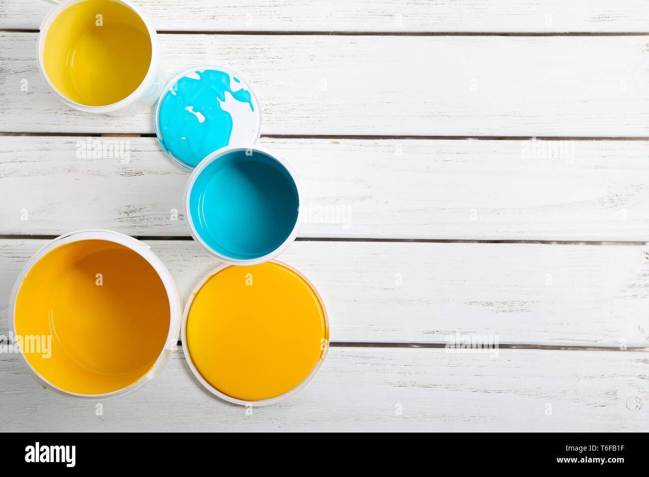 Paint cans on wooden table Stock Photo