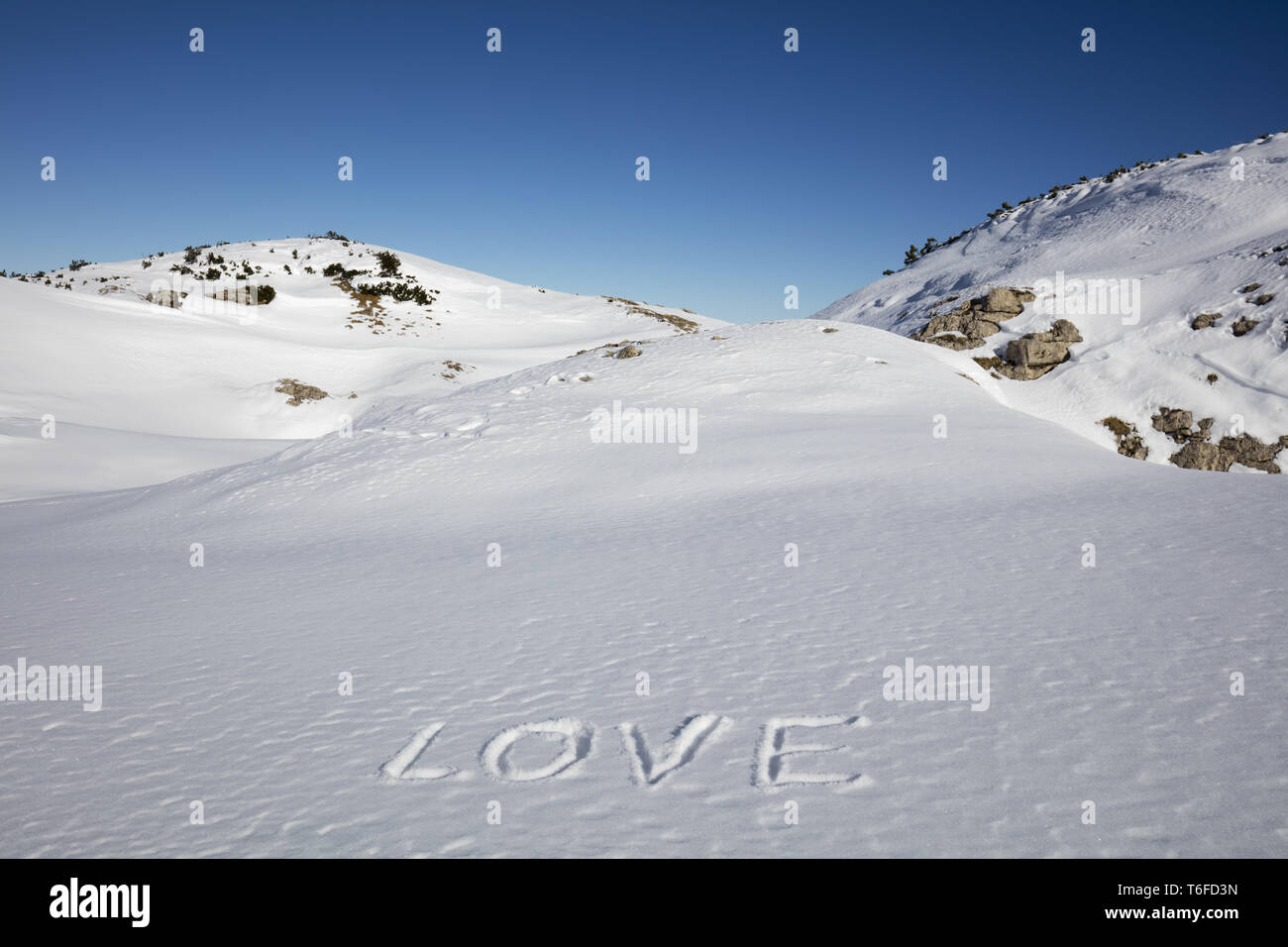 Writing Love in snow Stock Photo