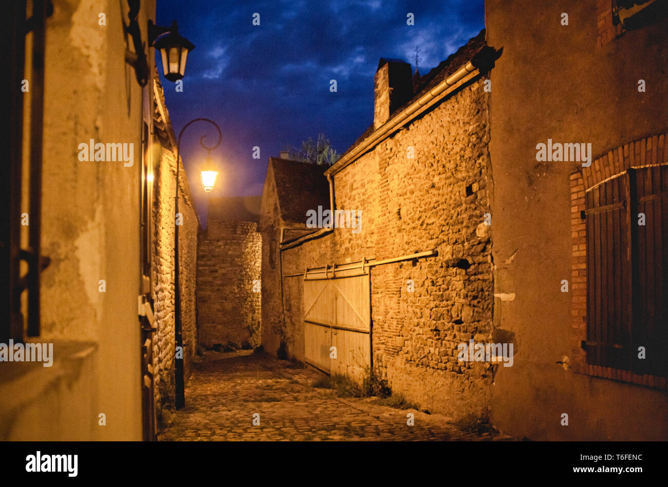 Castle street by night lit by lamps Stock Photo