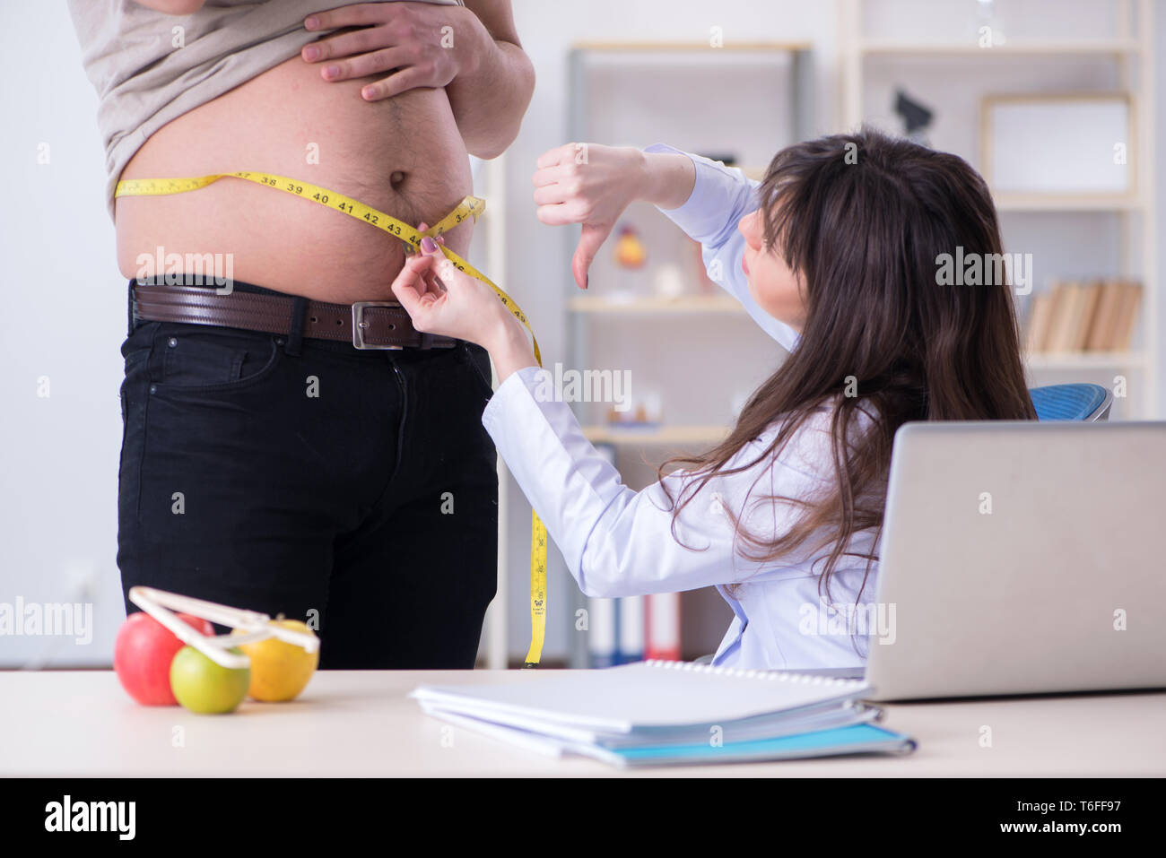 Doctor dietician giving advices to fat overweight patient Stock Photo