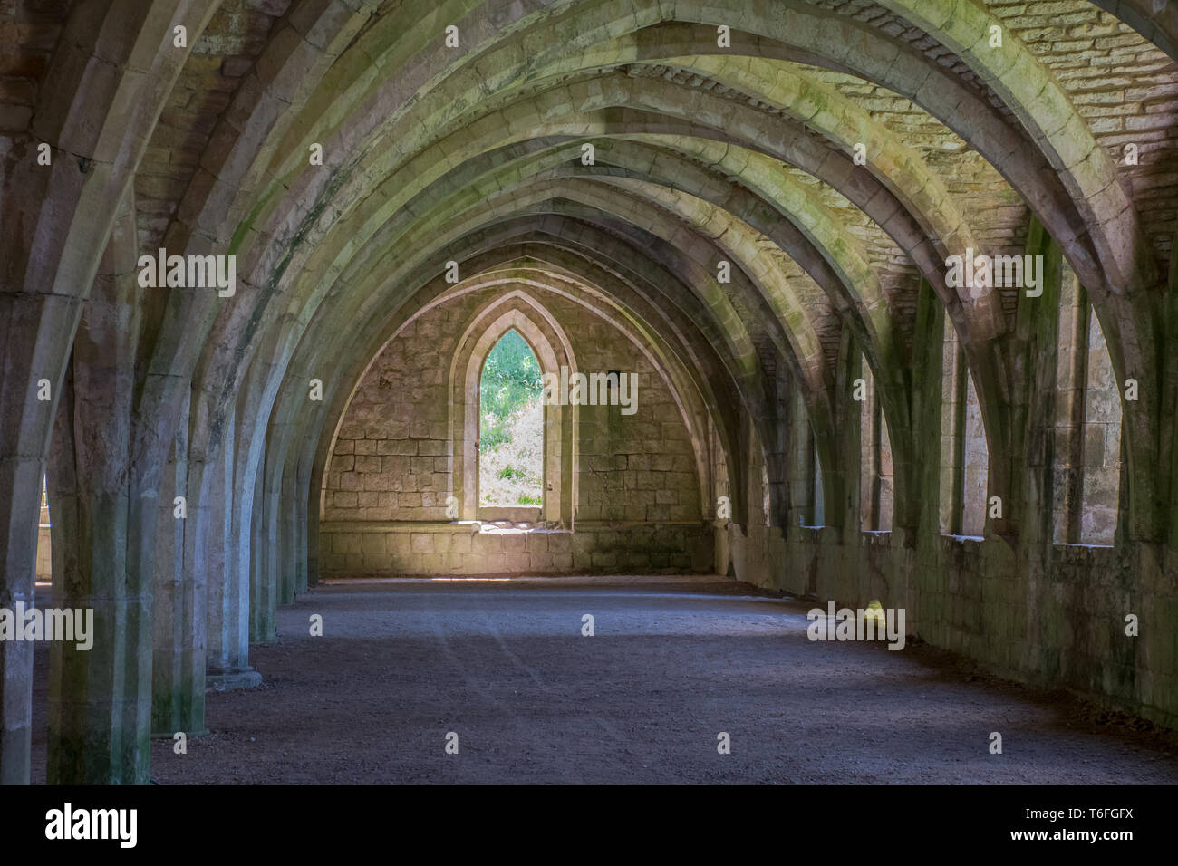 Ancient corridor in monastery with arches Stock Photo