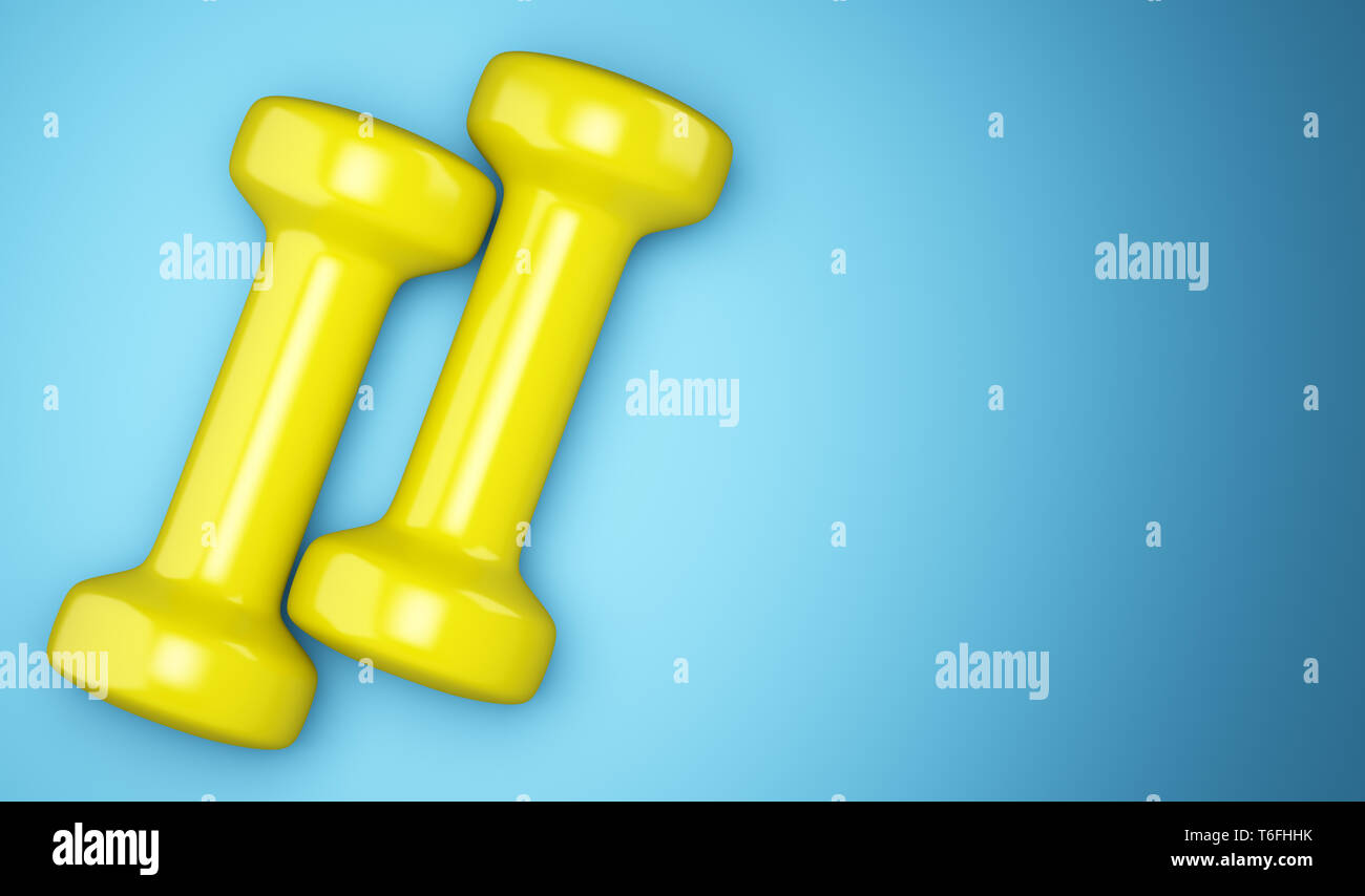 yellow dumbbells isolated on blue background Stock Photo