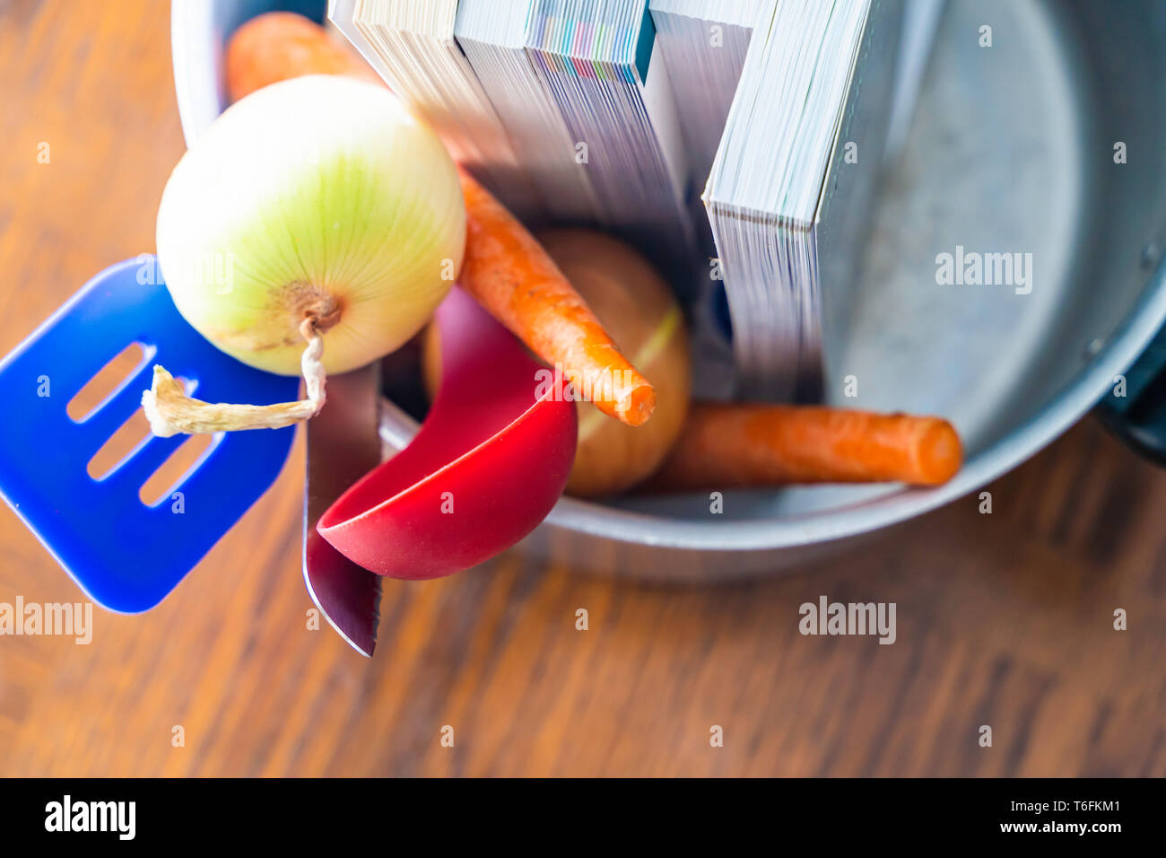 Books in pot ready to be cooked - Fraud Concept Stock Photo