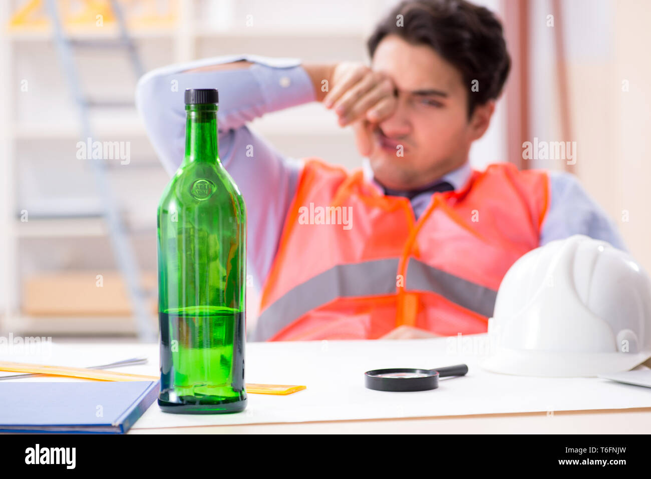 Drunk engineer working in the workshop Stock Photo