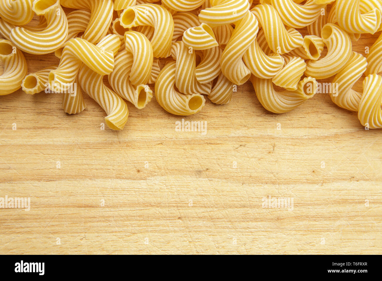 dried pasta on wooden background. Stock Photo