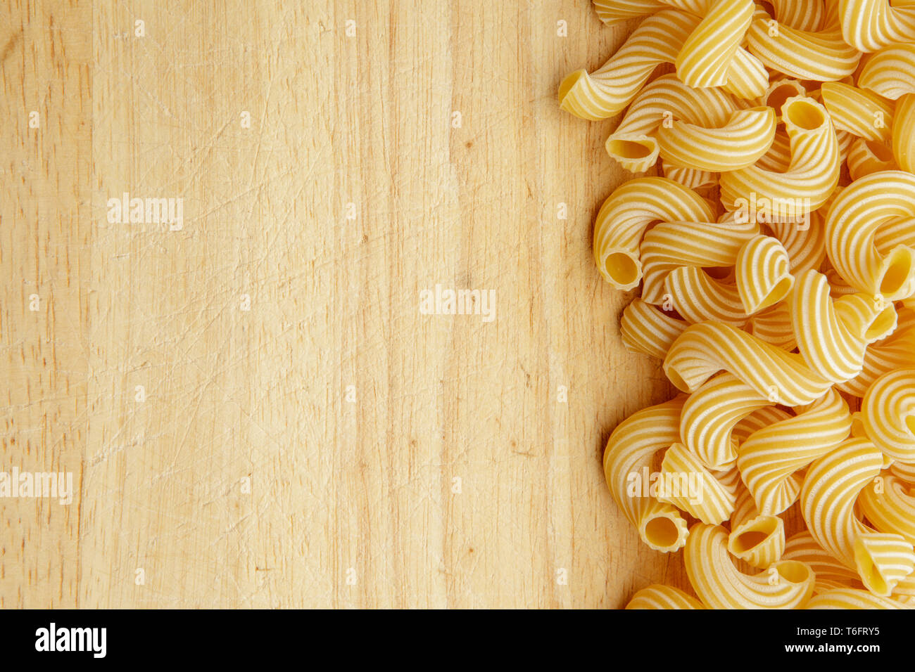 dried pasta on wooden background. Stock Photo