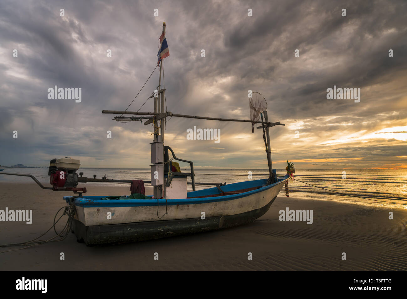 Fish boat rest on a beach Stock Photo