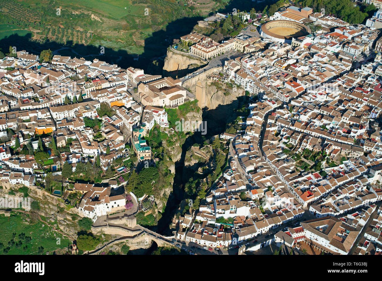 AERIAL VIEW. Historical picturesque city bisected by a deep canyon. Ronda, Andalusia, Spain. Stock Photo
