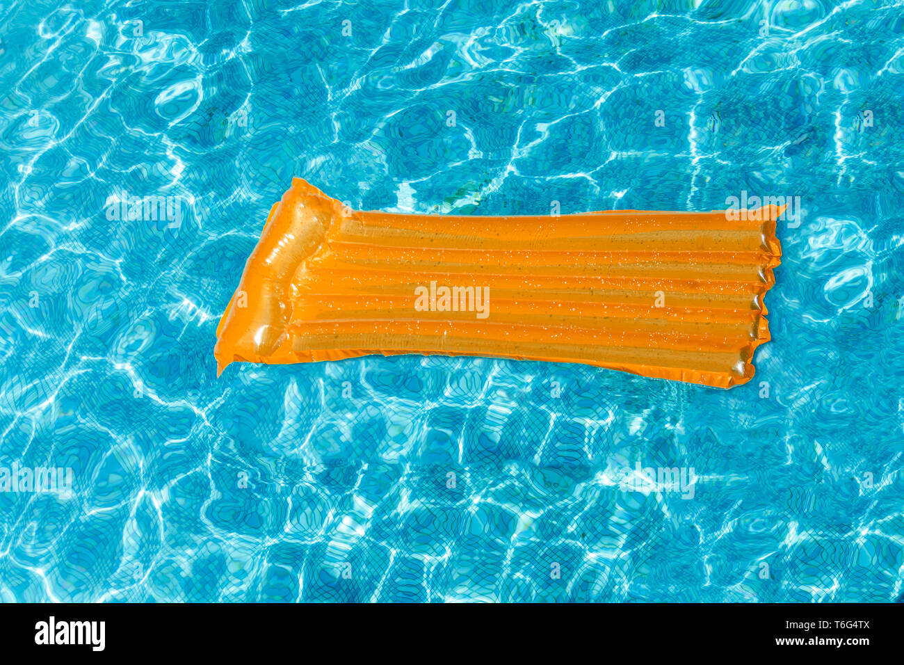 Inflatable water activities mattresses float on the water in the pool