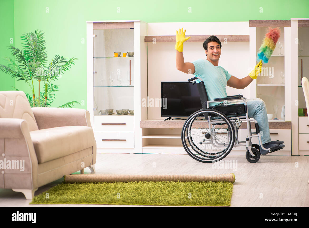 Disabled man on wheelchair cleaning house Stock Photo Alamy