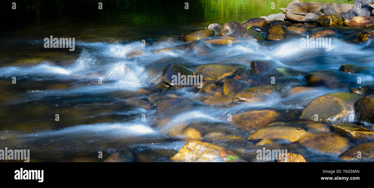 Stream flowing over rocks, Ovens River, Bright Victoria Australia Stock Photo