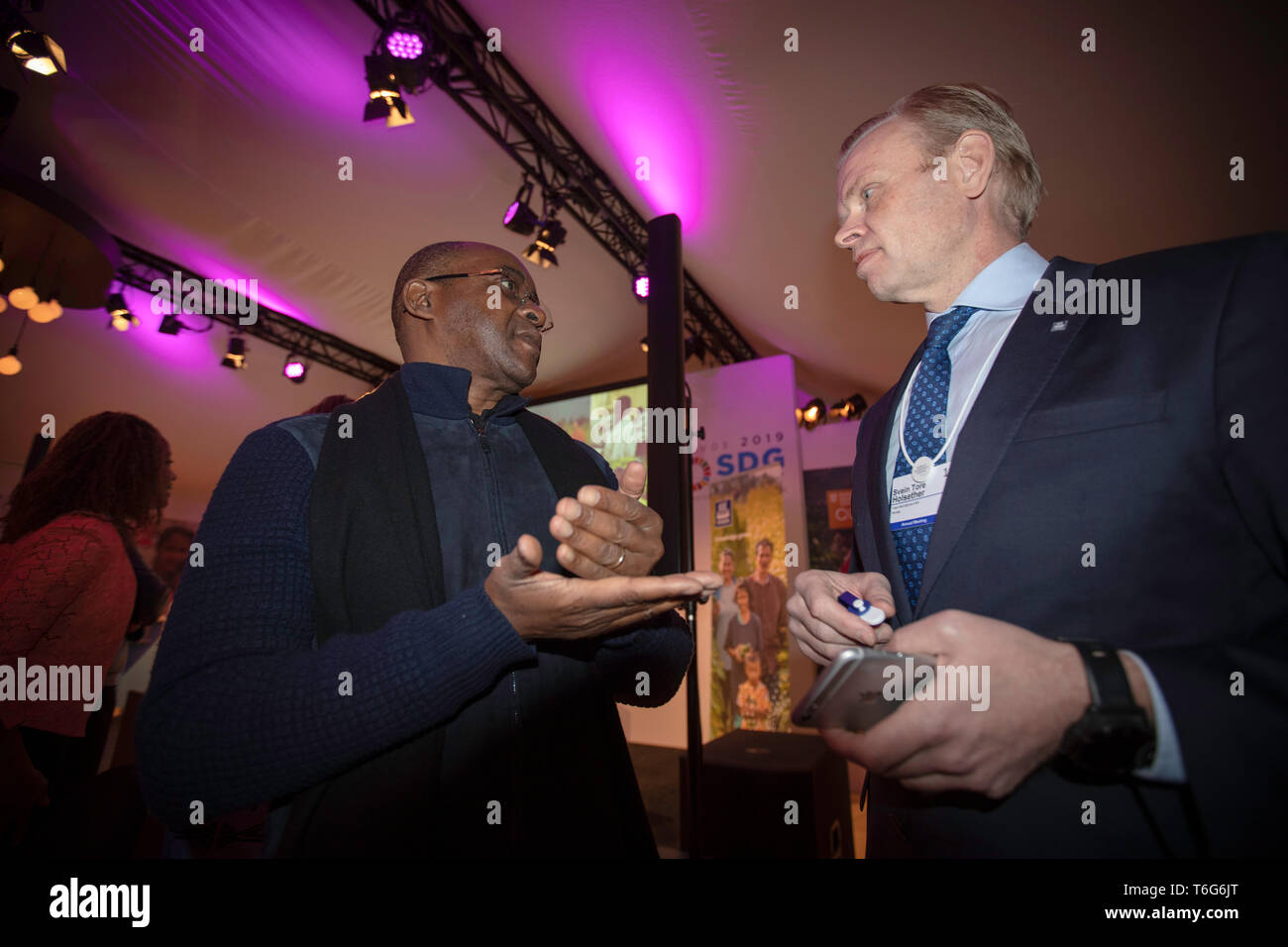 CEO of Yara, Svein Tore Holsether with Econet founder Strive Masiyiwa at the World Economic Forum. Holsether and Yara are introducing a cheap micro sensor that reads the nitrogen values in crops, making it possible to tailor the use of fertilizer to optimize growth. Econet could possibly be a partner by distributing the sensor to customers who are in the farming business. Stock Photo