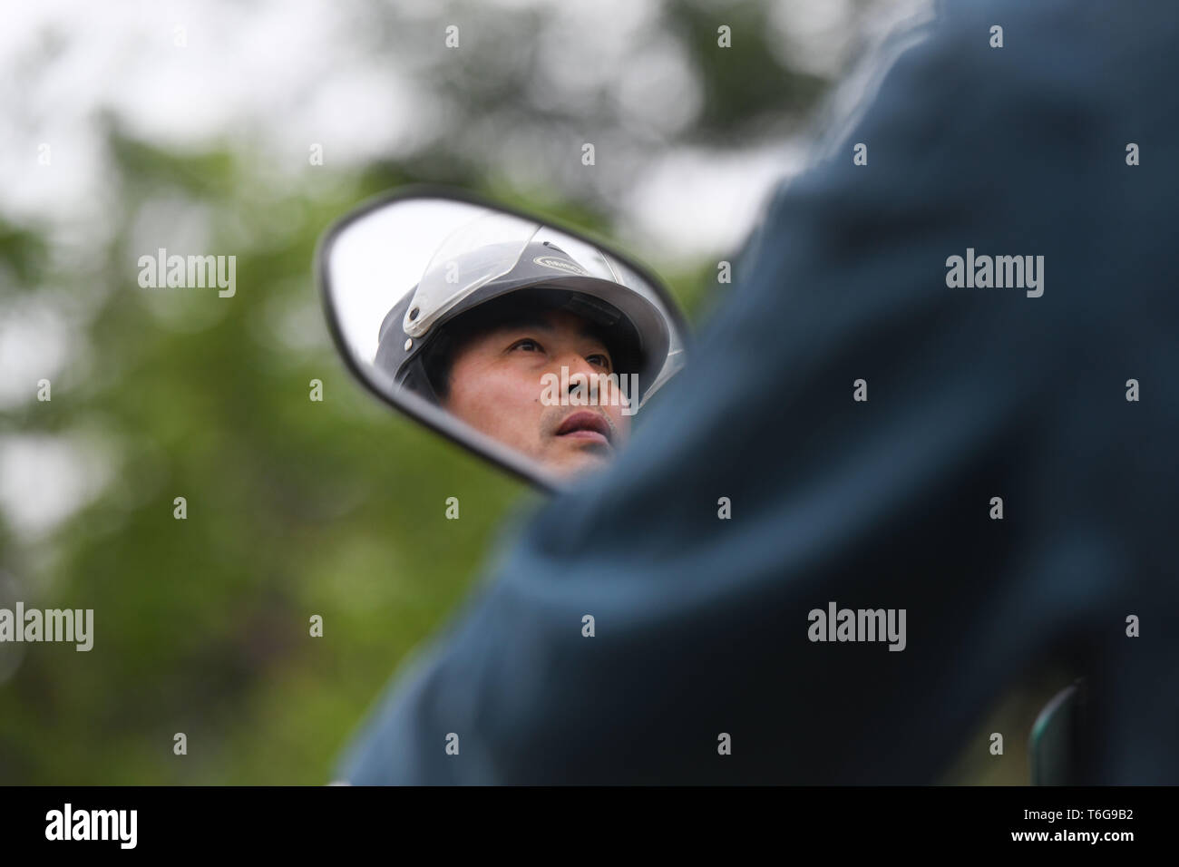 (190501) -- CHAOHU, May 1, 2019 (Xinhua) -- Postman Zheng Aijun is on the way to deliver postal packages in Sanbing Township of Chaohu City, east China's Anhui Province, April 30, 2019. In almost 36 years of working as a postman, Zheng Aijun has been delivering parcels in five villages of Sanbing Township. Apart from handling packages, Zheng also hands goods of daily use to left-behind elderly and donates money to orphans. Despite inconvenient working conditions, Zheng sticks to his post and is dedicated to serving people in the town. (Xinhua/Zhang Duan) Stock Photo